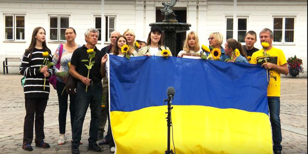 Ukrainska flyktingar sjunger den ukrainska nationalsången framför Gamla Rådhuset i Ystad, augusti 2022