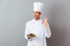 cook-uniform-holding-salad-showing-okay-gesture_171337-5345.jpg